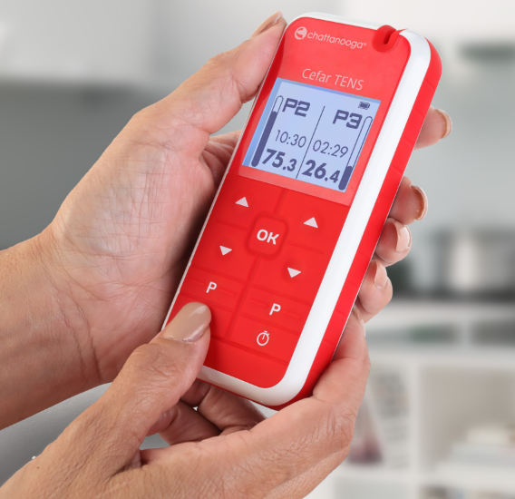 Cefar Muscle Stimulator & TENS device in use, showing control panel and display.