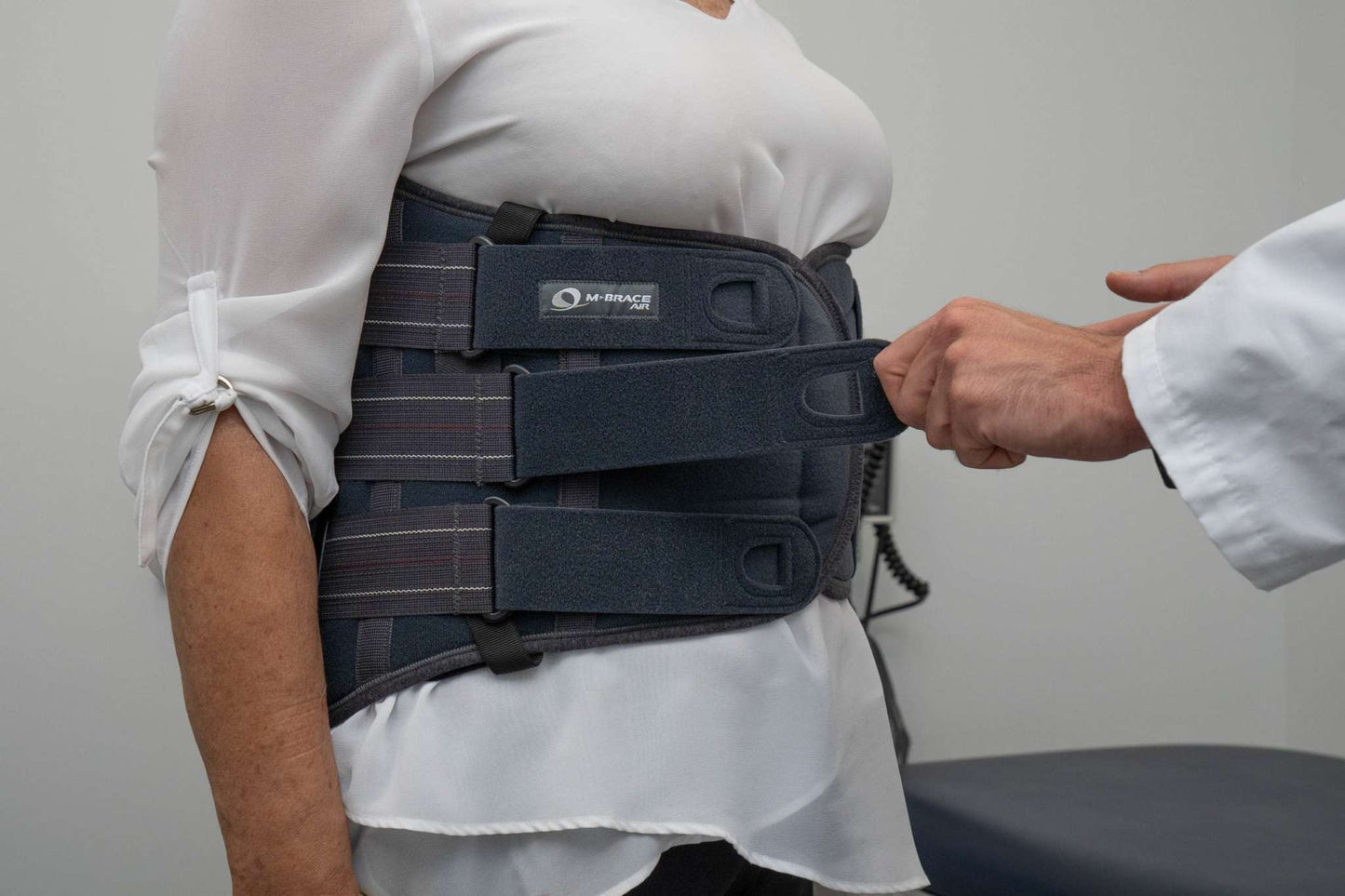 M-Brace M-Spine LSO back support brace being fitted on a person.