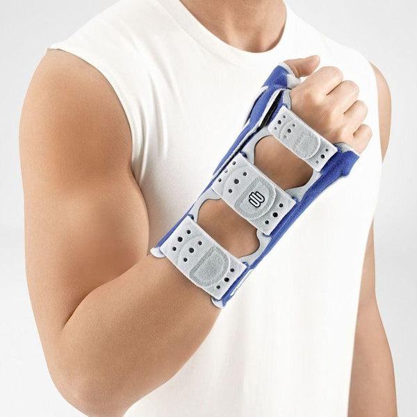 Man wearing ManuLoc Rhizo Wrist Brace for thumb and wrist support.