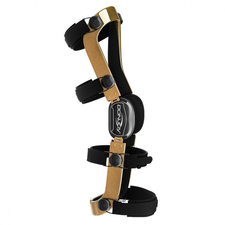 DEFIANCE III knee brace with carbon fiber frame and adjustable straps.