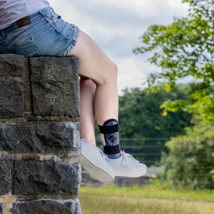 AirLoc Ankle Brace with adjustable air cushions worn outdoors.