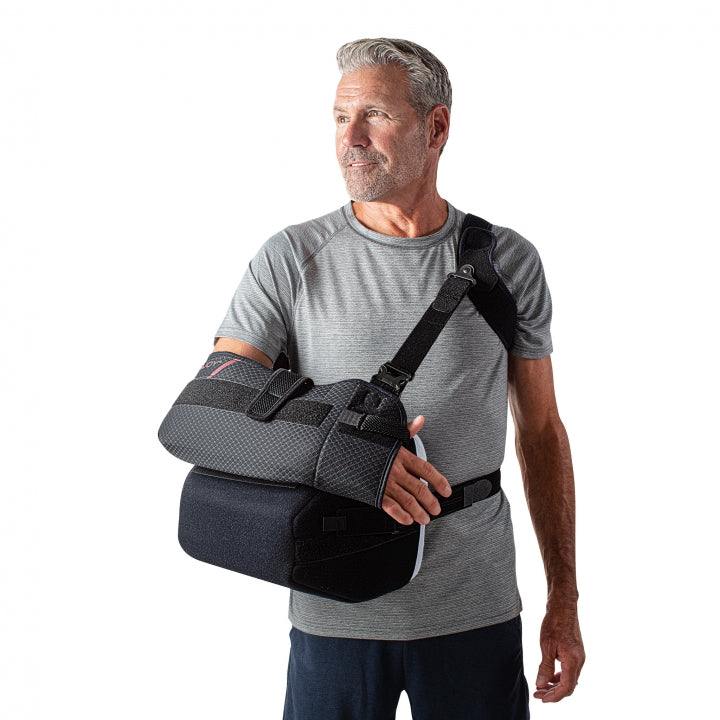 Man wearing ULTRASLING® PRO arm sling showcasing adjustable strap and support features.
