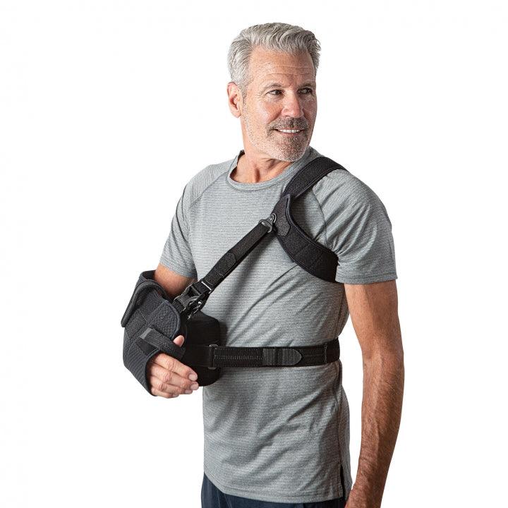 Man wearing Ultrasling® PRO shoulder sling and strap system.