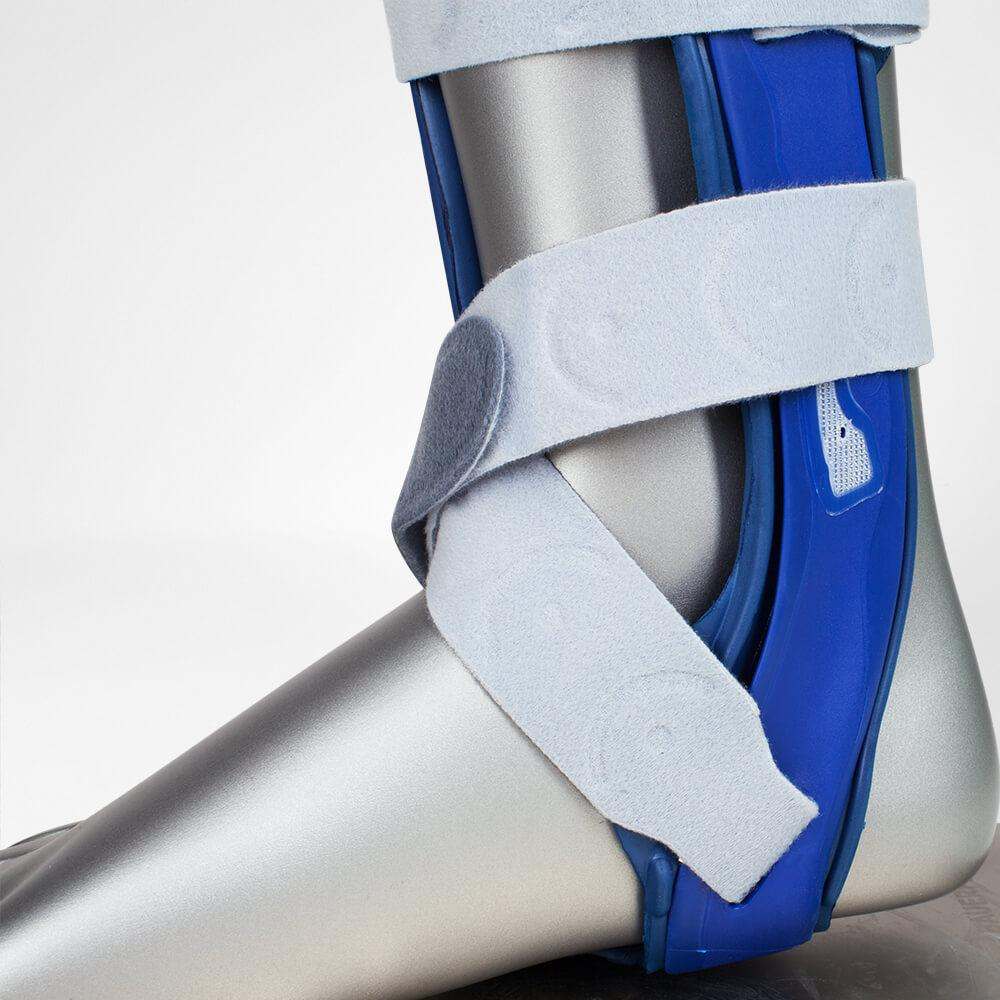 MalleoLoc Ankle Brace stabilizing orthosis with Velcro strap system on mannequin leg.