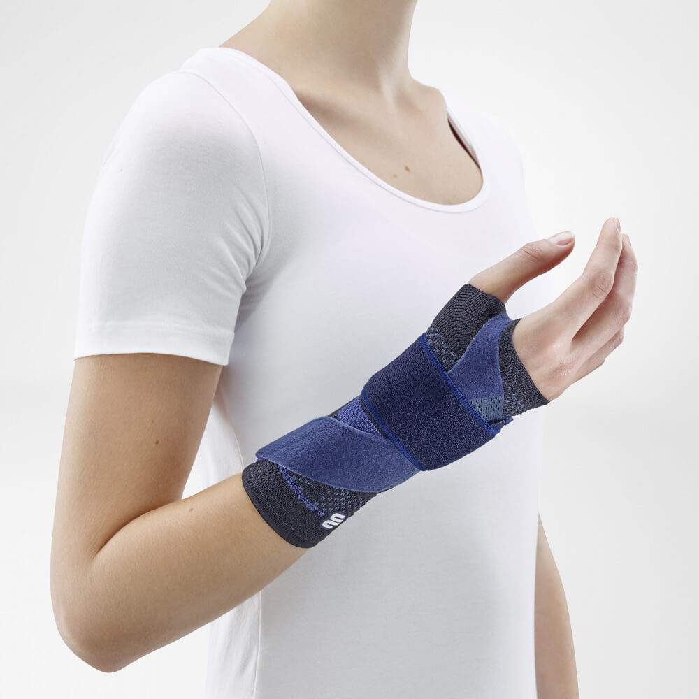 Bauerfeind ManuTrain wrist brace worn by person, providing adjustable stabilization and comfort.