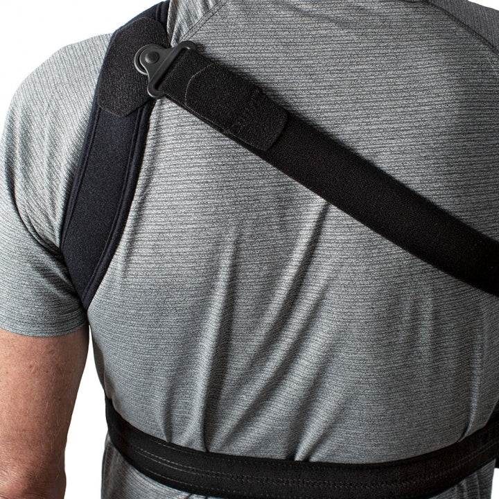 ULTRASLING® PRO shoulder strap showcased on a person wearing a gray shirt, highlighting easy application and comfort features.