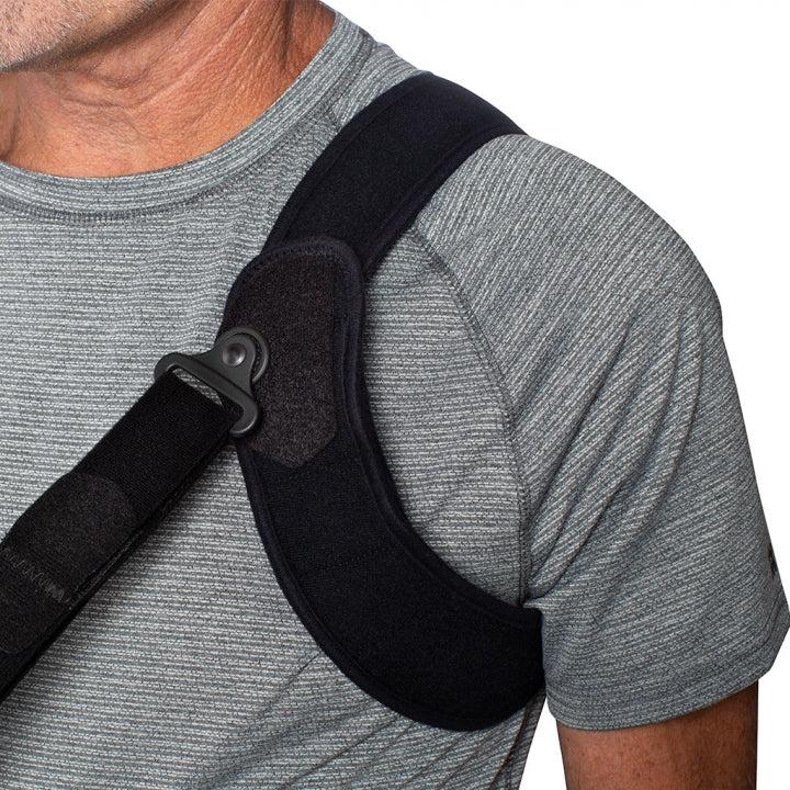 Shoulder strap system of ULTRASLING® PRO worn by a person in a gray shirt.