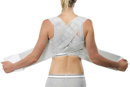 Back view of a person wearing the M-Brace Clavicle support showing crossed elastic bands for posture correction.