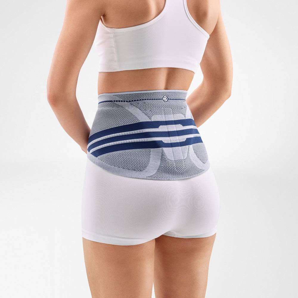 Lady wearing LumboTrain Lady Back Brace for back pain relief and posture support.