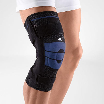 Bauerfeind GenuTrain S knee brace on leg, showing adjustable straps and breathable fabric for knee support.